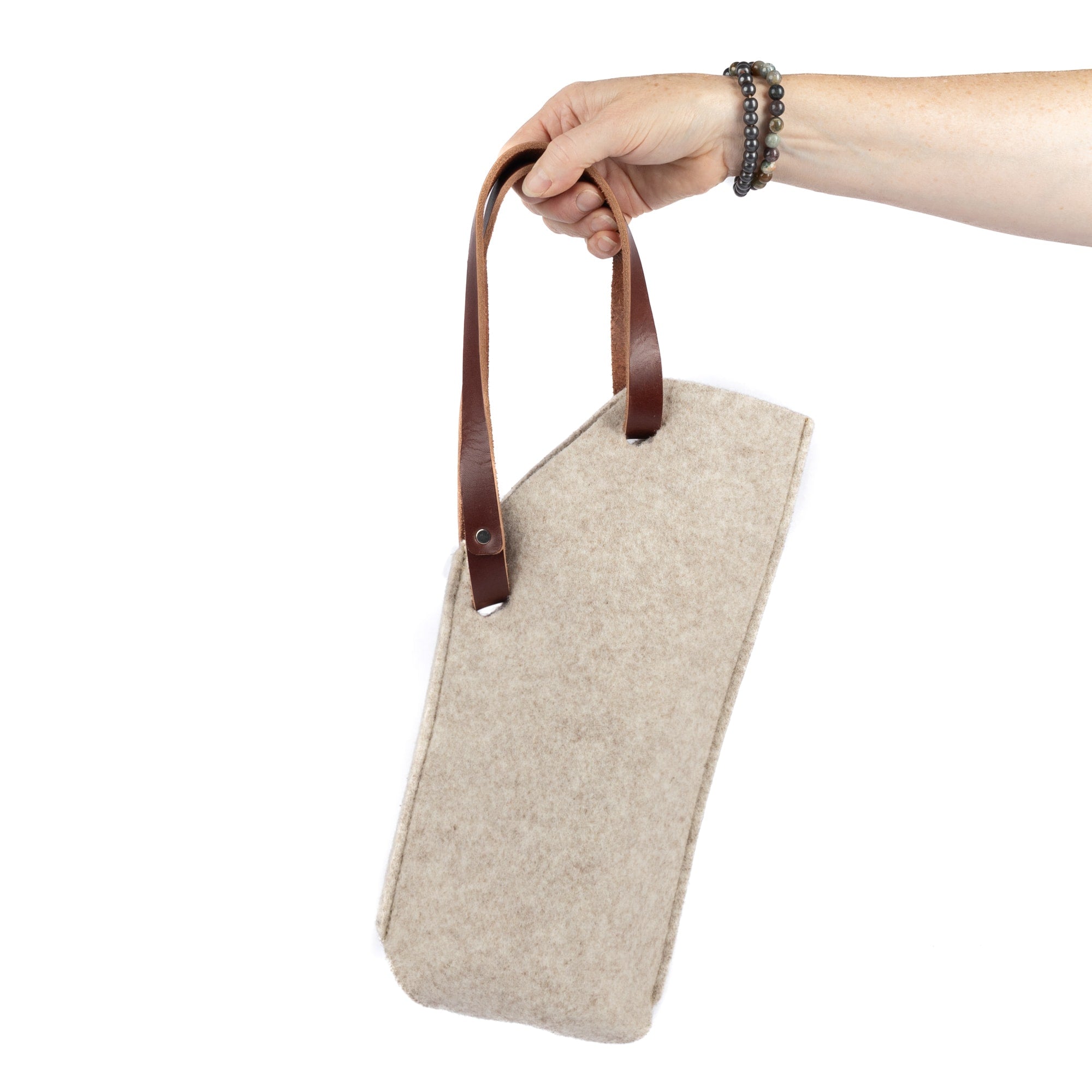 Single bottle felt wine sling by sonoma county leather in oatmeal hand holding