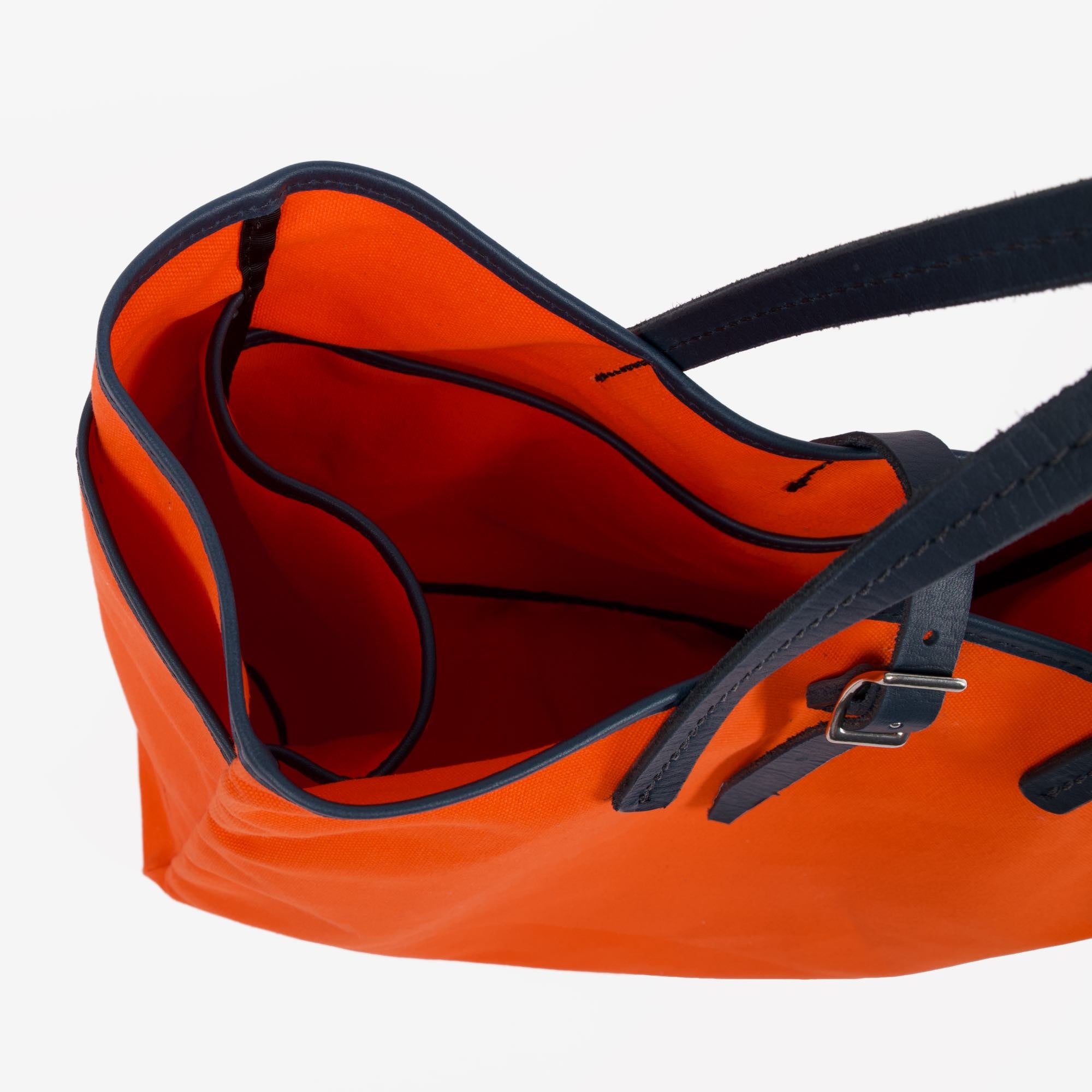 Day and night tote in orange navy by sonoma county leather above interior view
