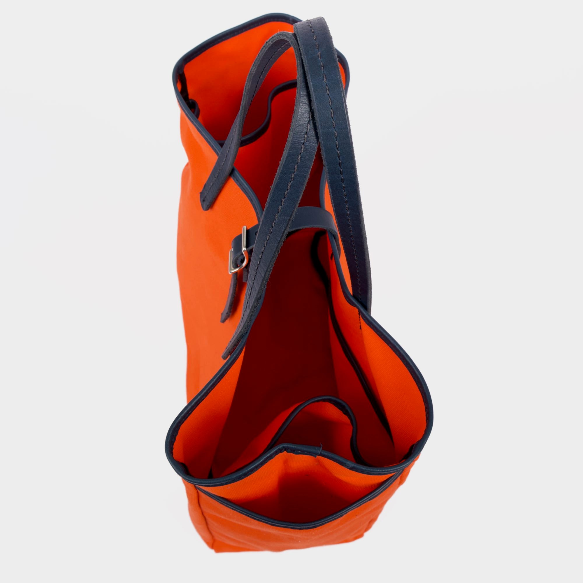 Day and night tote in orange navy by sonoma county leather above side view