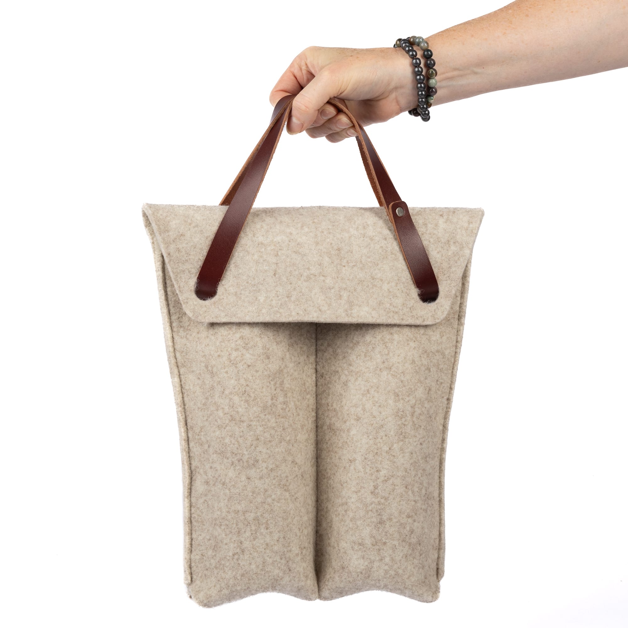 Felt double bottle wine bag by sonoma county leather in oatmeal hand holding