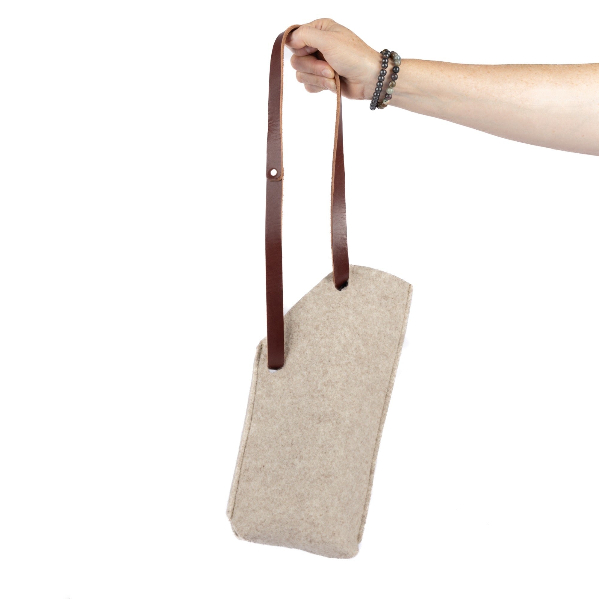 Single bottle felt wine sling by sonoma county leather in oatmeal long handle hand holding back