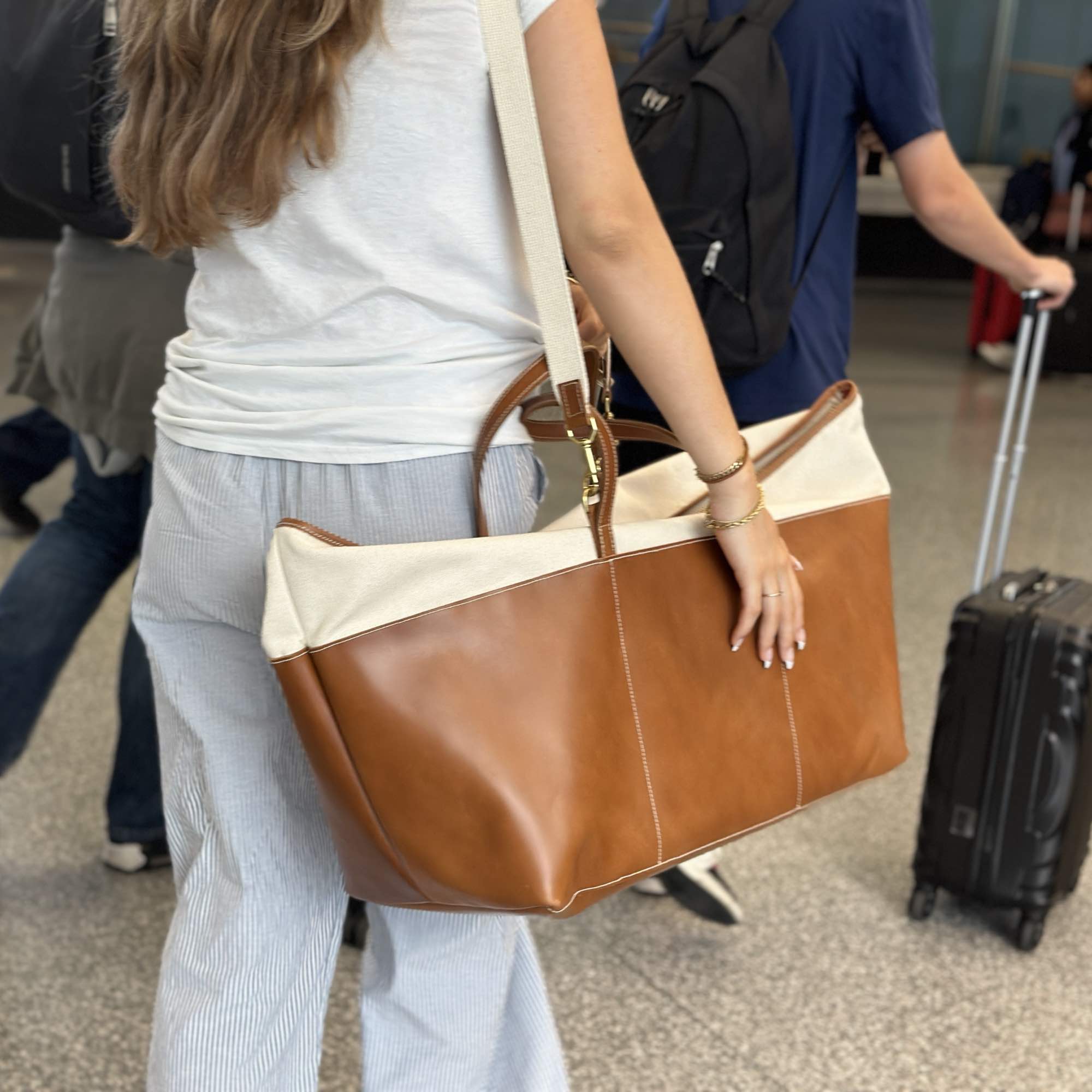 Tuscany weekender bag in natural canyon by sonoma county leather airport walking forward